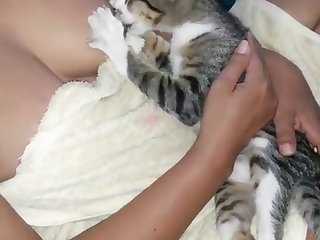 A Woman Breastfeeding A Kitten