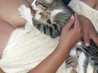 A Woman Breastfeeding A Kitten